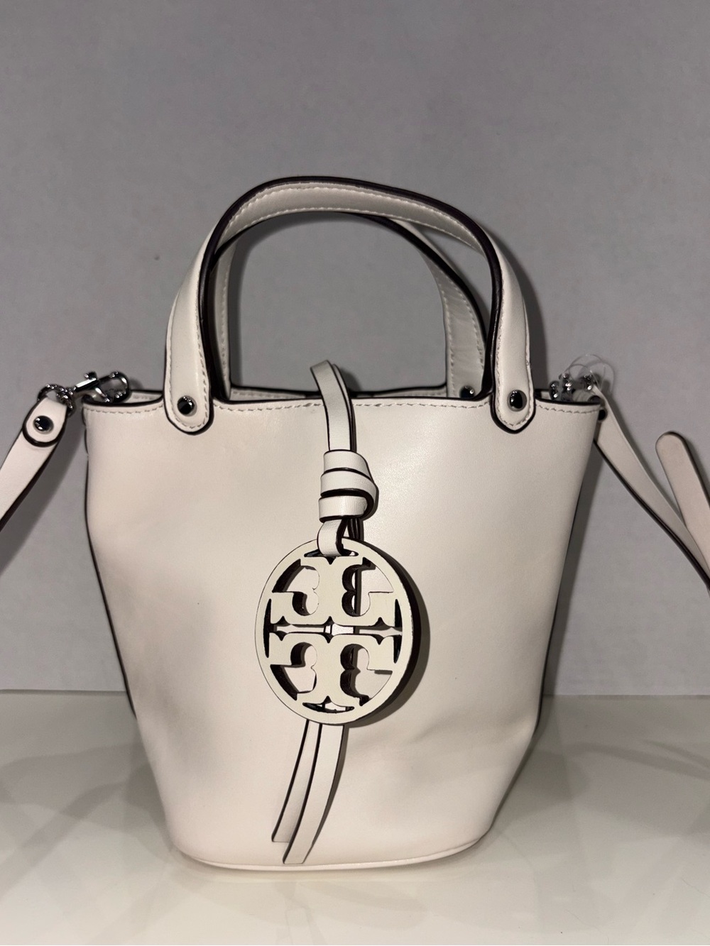 Tory Burch Off-White Leather Mini Bucket Bag with Logo Charm